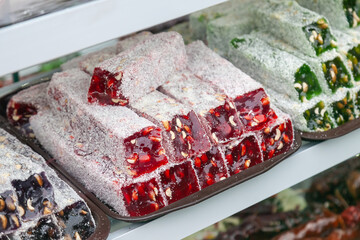 In front of store selling Turkish delight, various locum, arranged like pyramid, with knives,...