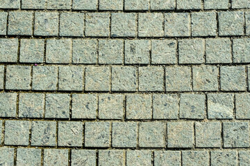 sidewalk gray tiles. Texture and appearance in the park
