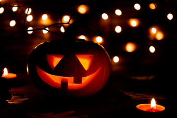  Traditional Halloween pumpkin glowing in the dark. Halloween greeting card concept, dark mood