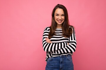 Portrait of positive cheerful fashionable woman in casual clothes isolated on pink background with copy space