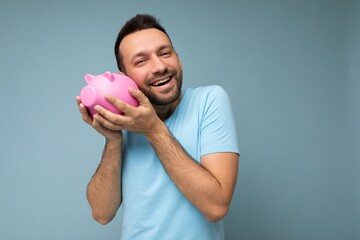 Photo of happy cute smiling young handsome brunet unshaven man with beard with sincere emotions...