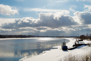 Winter view of the Volga river in the city of Kimry and a ship wintering near the shore