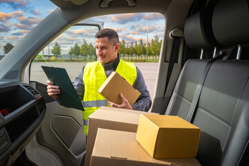 Truck driver with tablet in hand. Delivery of parcels. Satisfied man at work. Concept of...