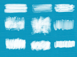 Set of white acrylic brushstrokes isolated on blue background
