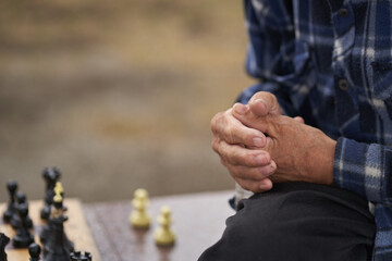 The hands of one of the men playing chess. Chess board game concept of business ideas and competition and strategic plan the meaning of success. High quality photo