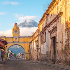 Santa Catalina arch and Agua volcano at sunrise, Antigua city, Guatemala.