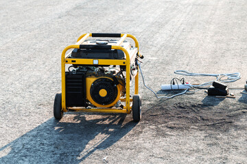 Petrol power generator on small wheels. Portable equipment for power supply of construction sites...