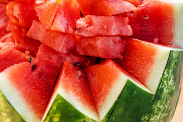 Pieces of juicy, ripe watermelon. Figured cutting of fruits and vegetables for table decoration. Close-up