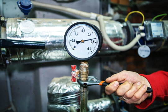 Repair of a pressure sensor in an industrial boiler room. Tighten the nuts to eliminate leakage at the pressure gauge connection. Close-up
