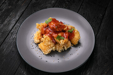 grilled chicken fillet with sauce on a dark background

