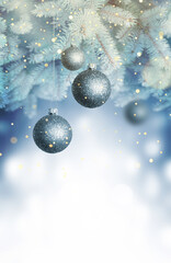 Christmas balls on a blue Christmas tree branch over blurred shiny background. Space for text