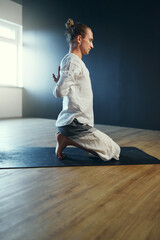 Fototapeta premium Man doing paschima namaskarasana. Yoga practice in the studio.