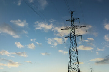 Telephone pole with cables under blue sky outdoors