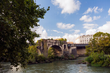 Fototapeta na wymiar Along the banks of the Tiber River in Rome. Ancient bridges