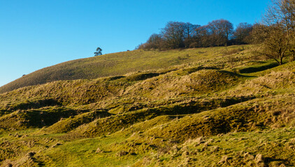 Fototapeta na wymiar sunrise view of the up-faulted Eastern edge of Martinsell Hill Fort in Pewsey Vale near Marlborough, Wiltshire, North Wessex Downs AONB