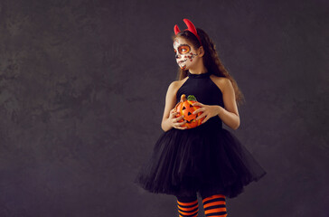 Child in Halloween costume. Portrait of little kid in scary outfit. Girl wearing beautiful black...