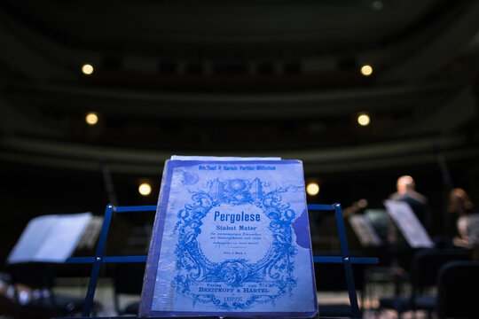 Old music book with notes of the cantata of Stabat Mater of the Italian composer of Pergolese on the stage of the Kharkiv Opera Theatre. Ukraine, Kharkiv, KHNATOB, on April 25, 2018