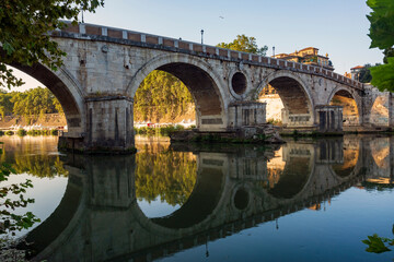 Fototapeta premium Along the banks of the Tiber River in Rome. Ancient bridges