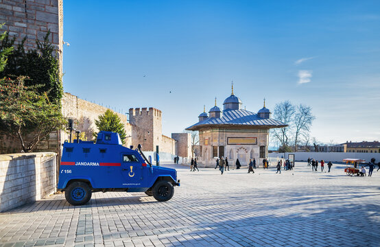 The blue armored car of the Turkish gendarmerie stands at the gate to the Topkapi Palace, next to the Sultan 3 Ahmed Kutuphanesi fountain. Turkey, Istanbul, January 16, 2019