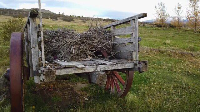 Old cart, wooden old cart. An old wooden cart with a load inside in a picturesque place. Rural atmosphere