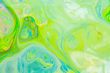 Green fluid art background. Liquid abstract pattern with UFO green. Marble texture of liquid surface. Fluid art