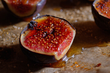 Halved fresh figs caramelized with honey and brown cane sugar. Close-up view.