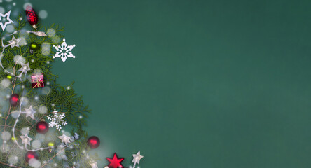 Christmas background with fir branches, decor and Christmas lights on it.