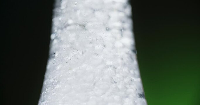 Close up video of the openning the bottle with soda water with bubbles in slow motion, 4k Prores HQ 120 fps