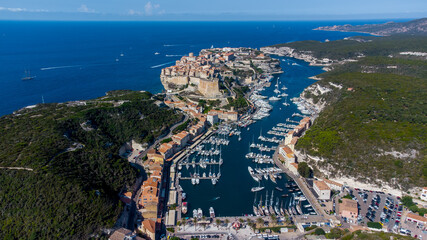 Aerial view of the marina and cape of Bonifacio in the south of the island of Corsica in France - Medieval citadel built on a rocky promontory overlooking the Mediterranean Sea