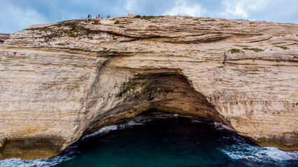 Aerial view of Napoleon's Hat, a marine cave dug in the limestone cliffs of Bonifacio in the Mediterranean Sea, in the south of Corsica, France