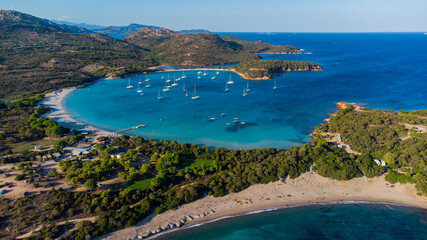 Naklejka premium Aerial view of the bay of Rondinara in the South of Corsica, France - Sandy beach in the shape of a seashell with turquoise waters in the Mediterranean Sea
