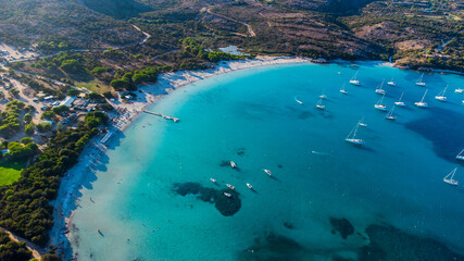 Aerial view of the bay of Rondinara in the South of Corsica, France - Sandy beach in the shape of a seashell with turquoise waters in the Mediterranean Sea - obrazy, fototapety, plakaty