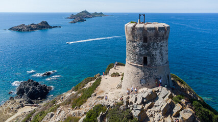 Aerial view of the remains of the Genoese Tower of La Parata built on an overlook at the end of a cape with the Sanguinaires Islands in the background - Corsica, France