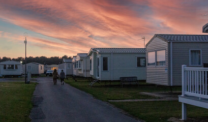 sunset over the mobile homes of a holiday park