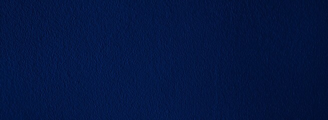 Elegant navy blue background with simple design and copy space.  Bluish abstract textured material, dark color wallpaper for wide banner, header, website template, etc.