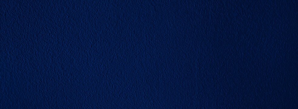 Elegant navy blue background with simple design and copy space.  Bluish abstract textured material, dark color wallpaper for wide banner, header, website template, etc.