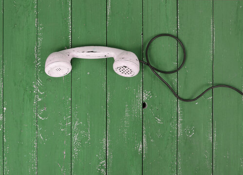 Top view White handset vintage phone green wood textured