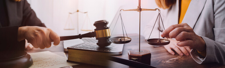 justice and law concept.Male judge in a courtroom on wooden table and Counselor or Male lawyer...