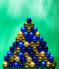 colored Christmas toys are scattered on the table in the form of a Christmas tree