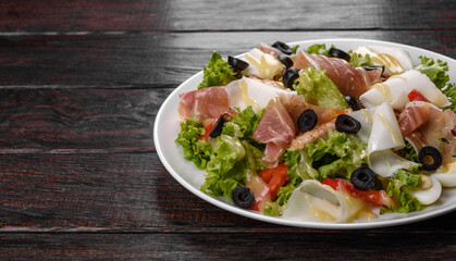 Delicious fresh salad with bacon for the festive table