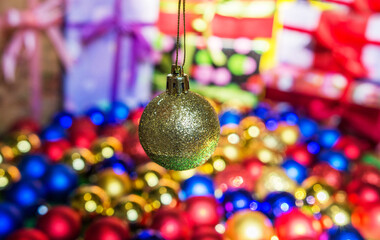 Christmas golden toy on a background of colored bokeh