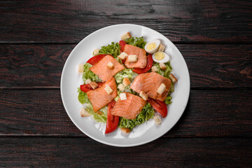 Delicious fresh salad with red fish for the festive table