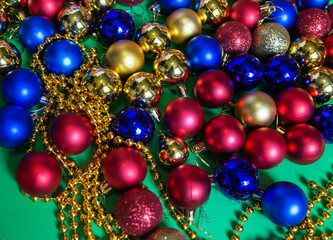 colored Christmas tree toys and beads are scattered on the table