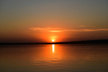 Obraz premium Romantic sunset , big sun in the sky in the evening. Orange air space