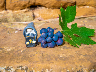 Preacher Gnome near grape and leaf in the garden