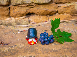 Beefeater British Royal Guard near a grape and leaf in the garden