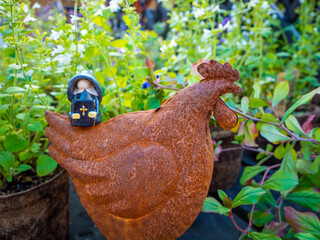 Preacher Gnome on a Metal Chicken in the garden