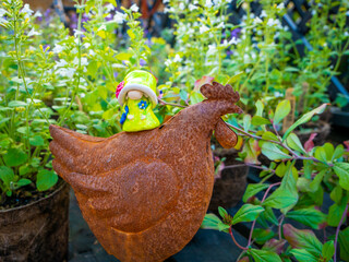 Queen Gnome on a Metal Chicken in the Garden