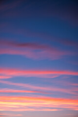 Clouds in the evening sky turn colors as the sun sets