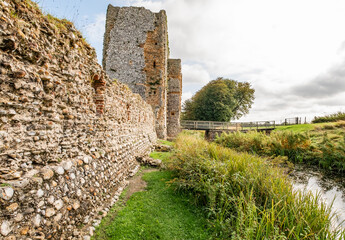 The stone and flint remains of a medieval disused and derelict castle in rural England. A well...
